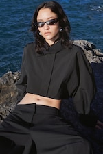 Placeholder for: person wearing black set by the beach