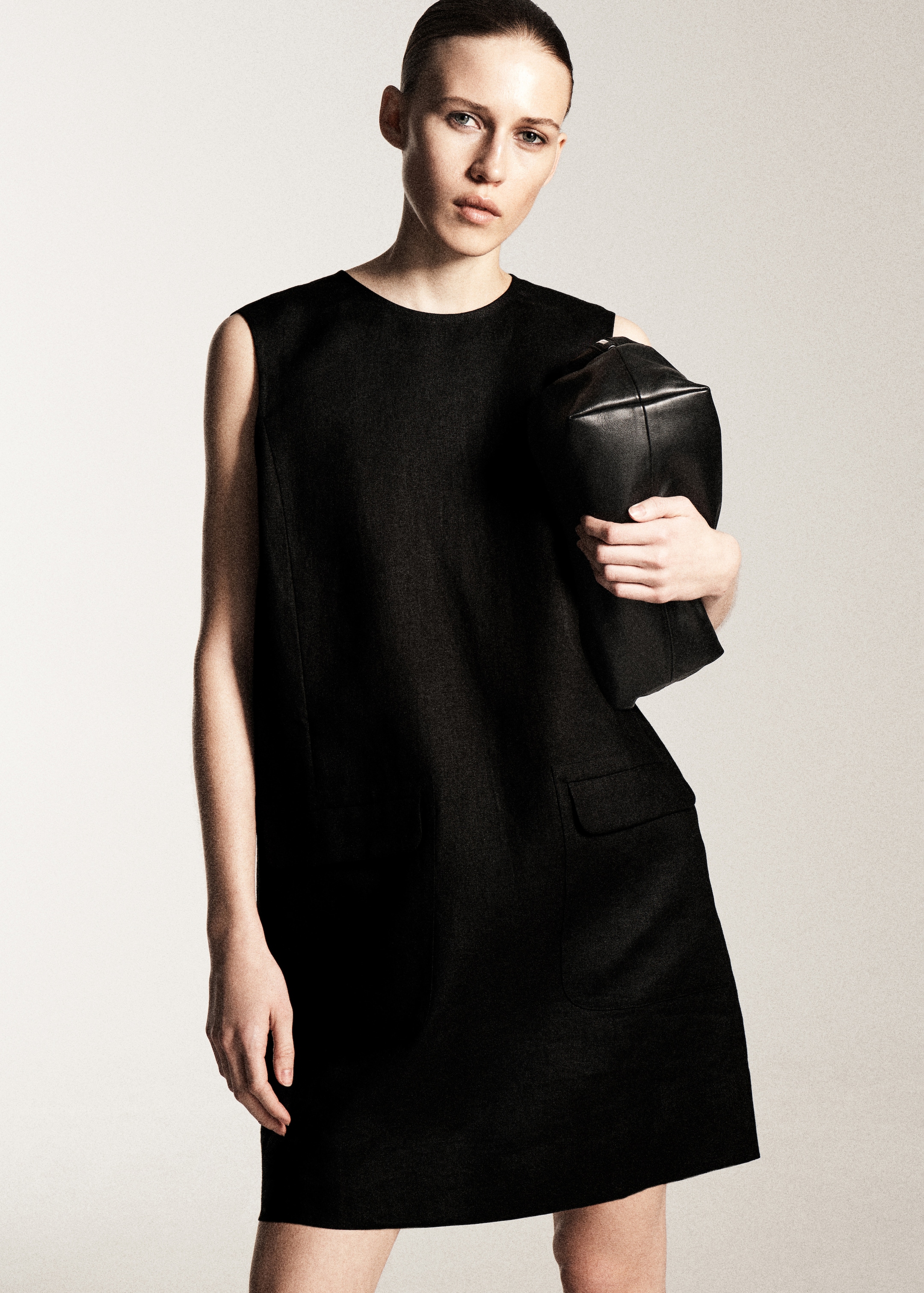 woman in black sleeveless mini dress