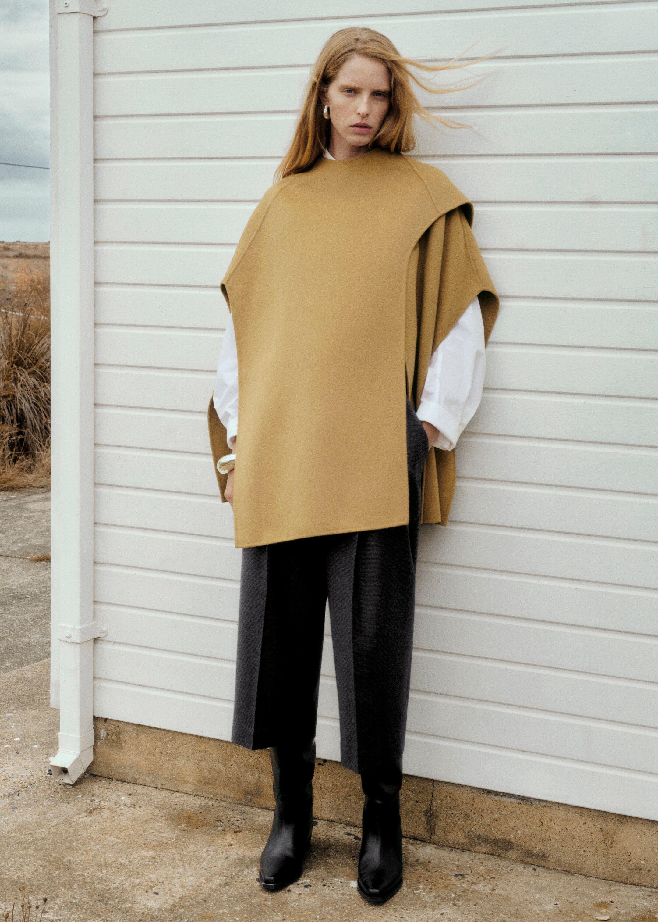 Woman wearing beige poncho