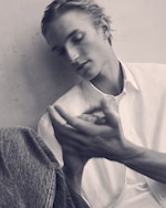 Placeholder for: Black & white image of a man in a white shirt & blue jeans