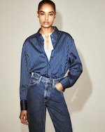 Placeholder for: model in white t-shirt layered with a Blue shirt and dark jeans