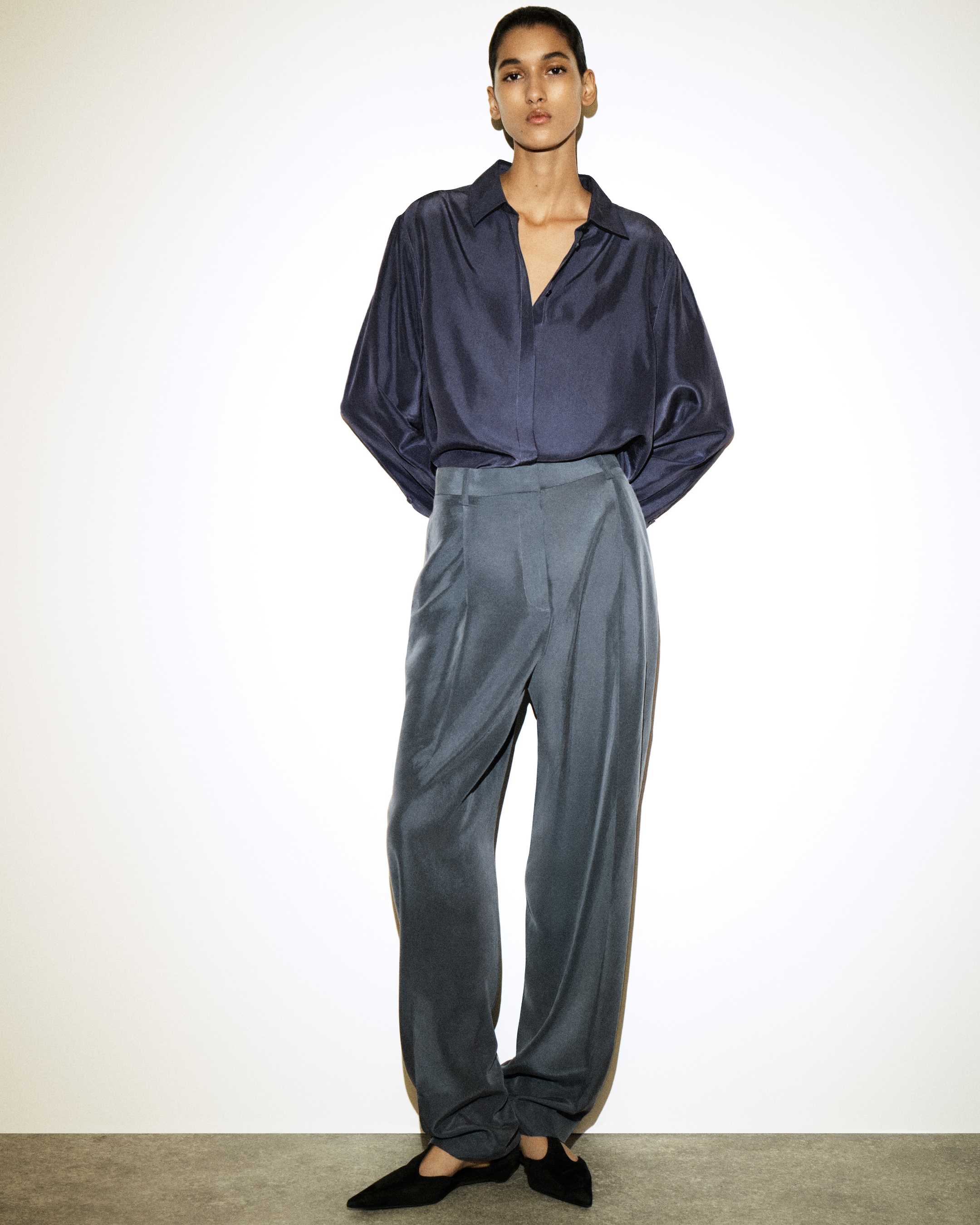 woman in blue silk shirt and trousers