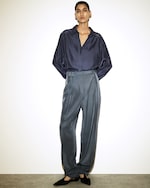Placeholder for: woman in blue silk shirt and trousers