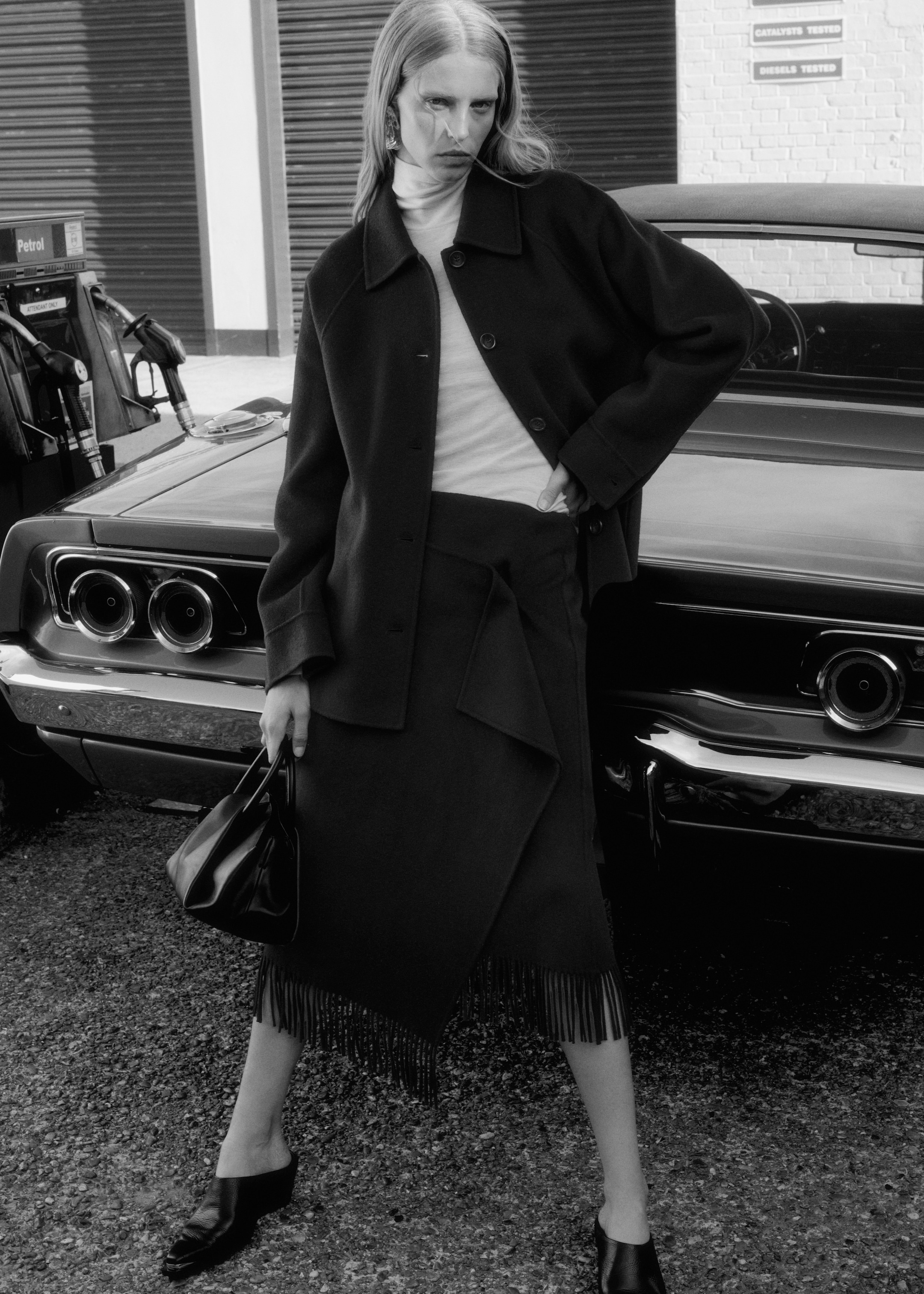 Woman looking over shoulder wearing black wool coat
