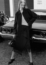 Placeholder for: Woman looking over shoulder wearing black wool coat