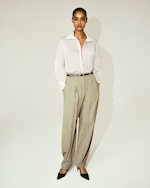 Placeholder for: Model in Striped button up shirt and cream trousers
