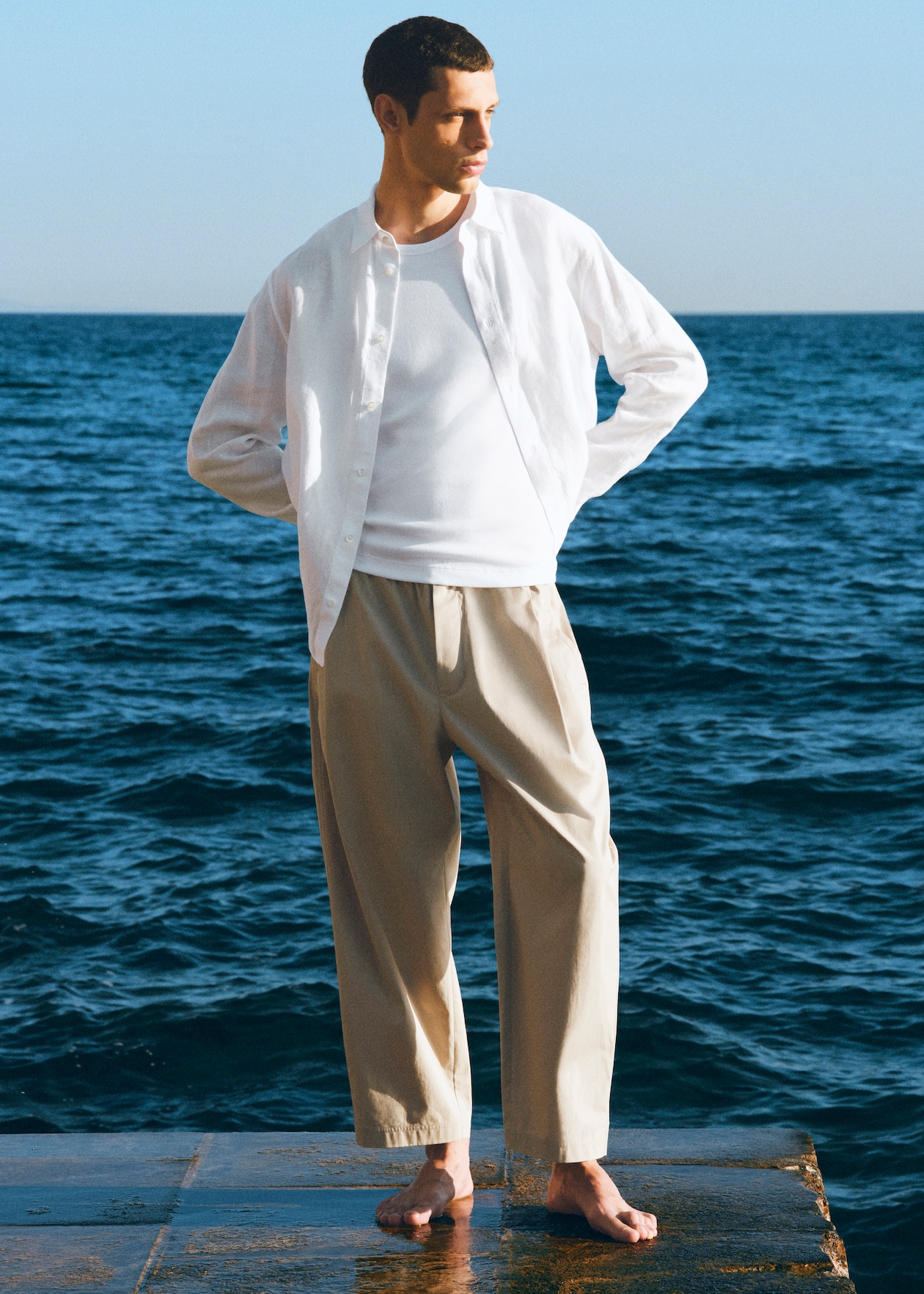 man wearing white shirt with sea as background