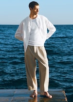 Placeholder for: man wearing white shirt with sea as background