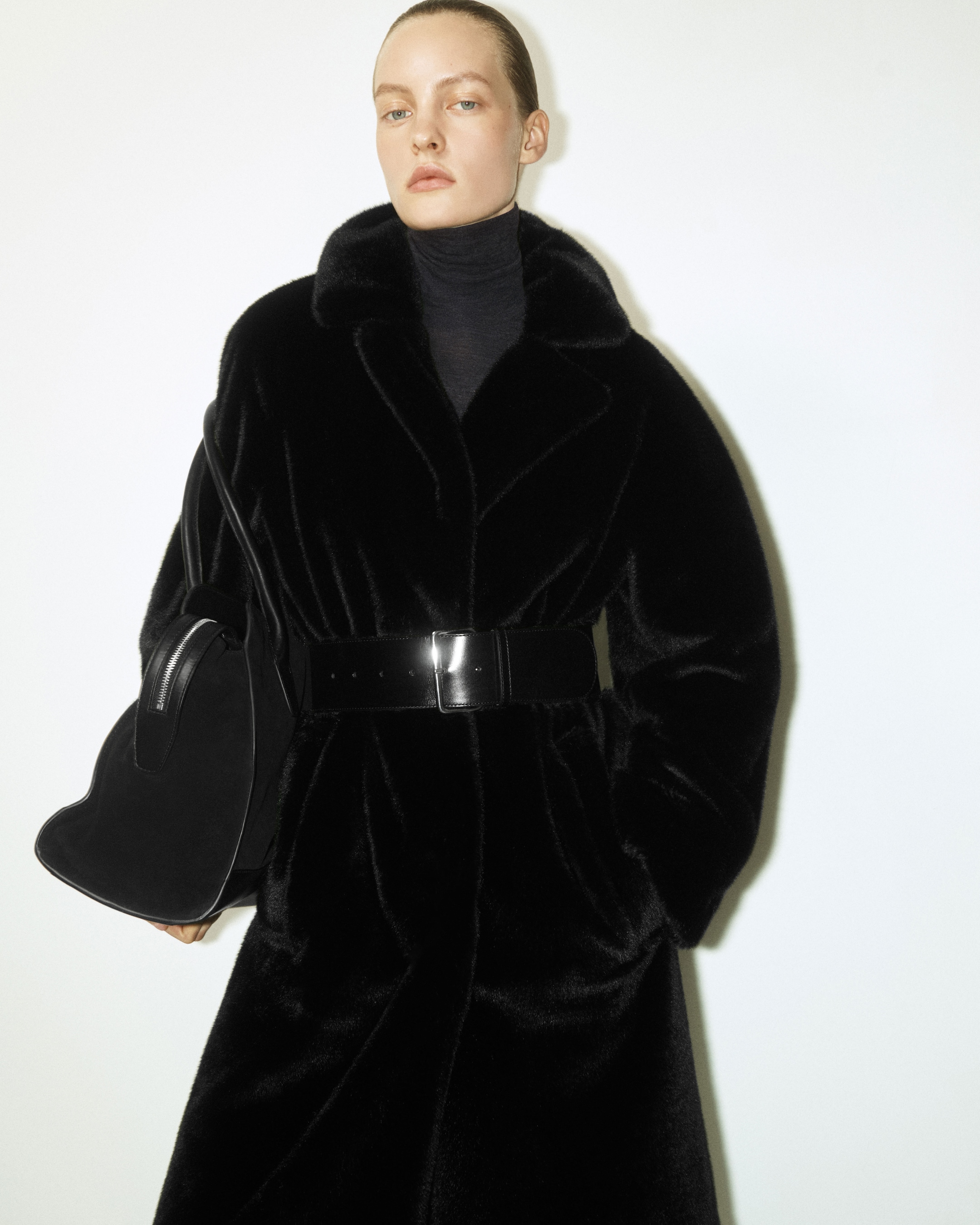 model wearing black coat