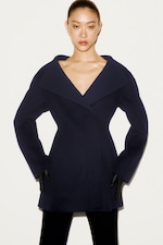 Placeholder for: Women in navy suit jacket and gloves