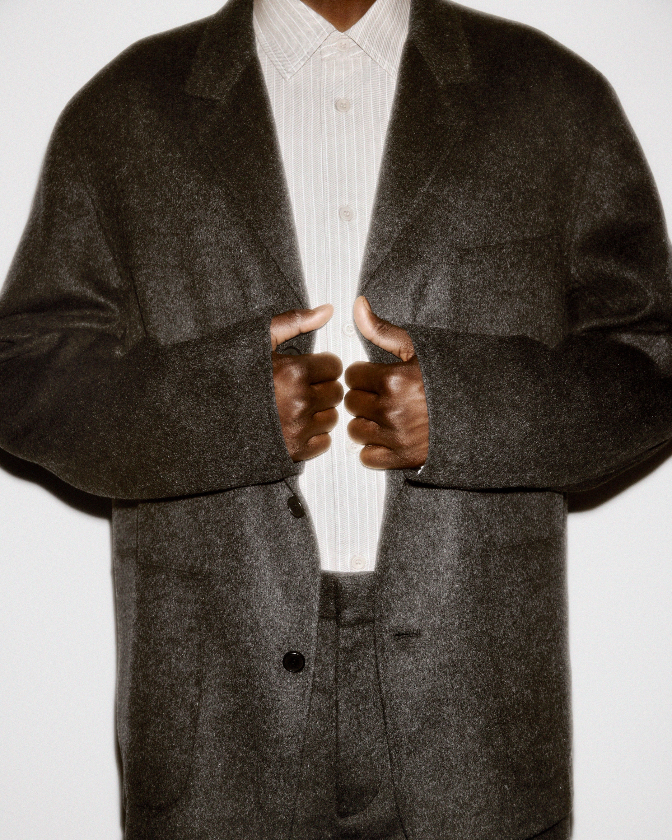 Man in wool jacket and stripe shirt