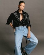 Placeholder for: Model in black leather button up and light wash jeans