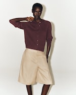 Placeholder for: woman in burgundy linen cardigan and shorts