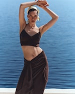 Placeholder for: woman in silk top by the sea