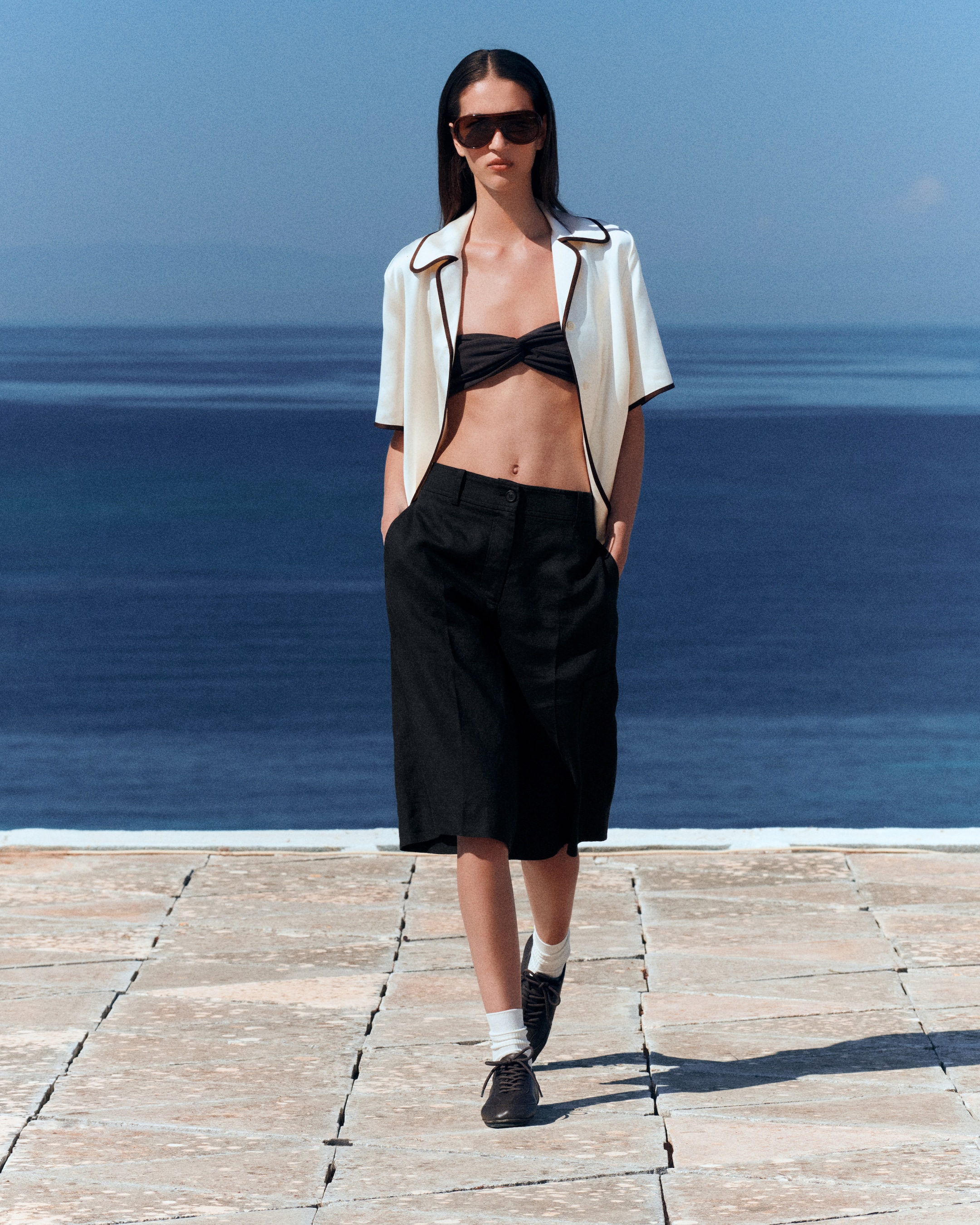 woman in silk shirt and black shorts