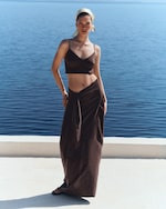 Placeholder for: woman in silk bralette and matching skirt by the sea