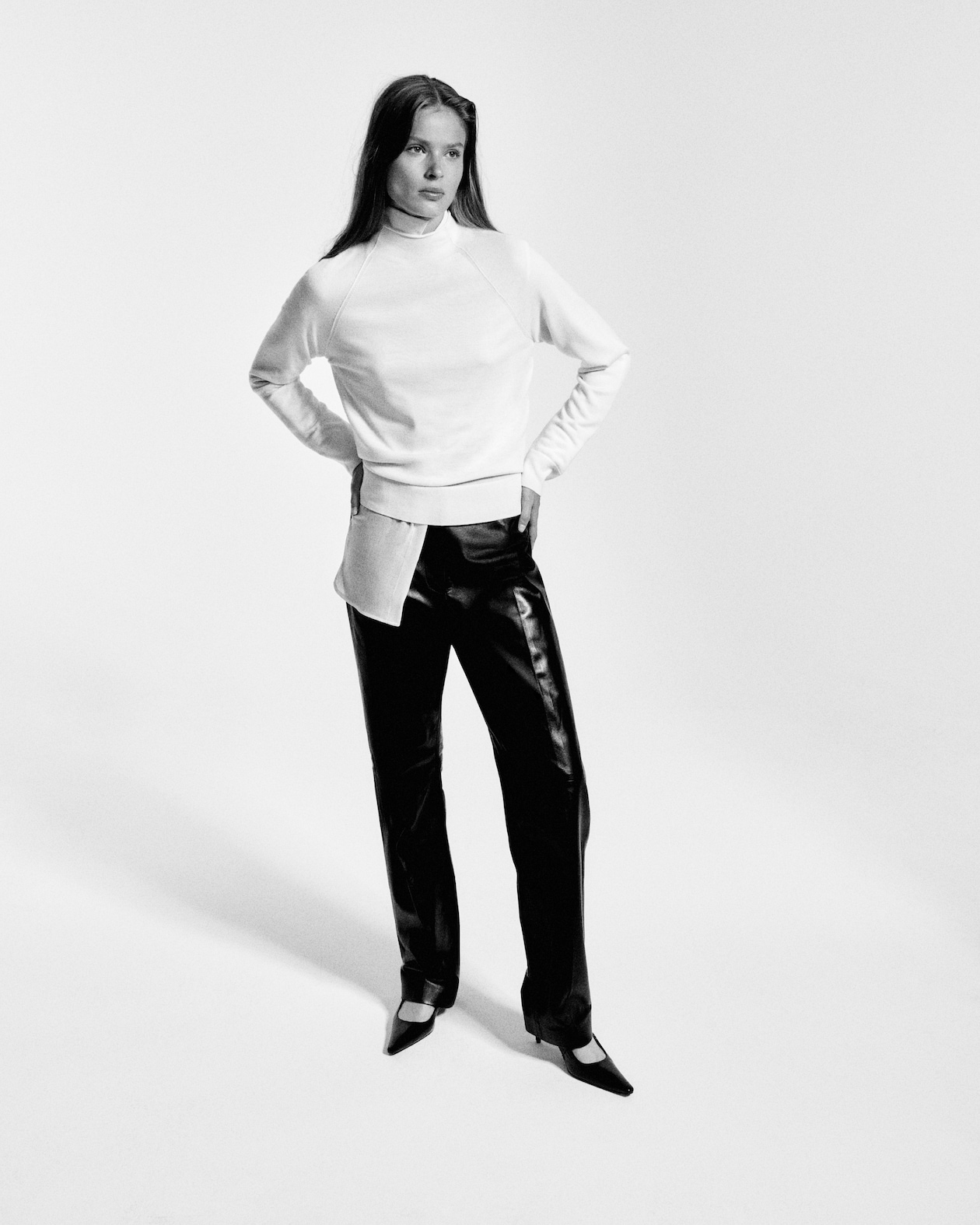 Model in leather trousers and white jumper