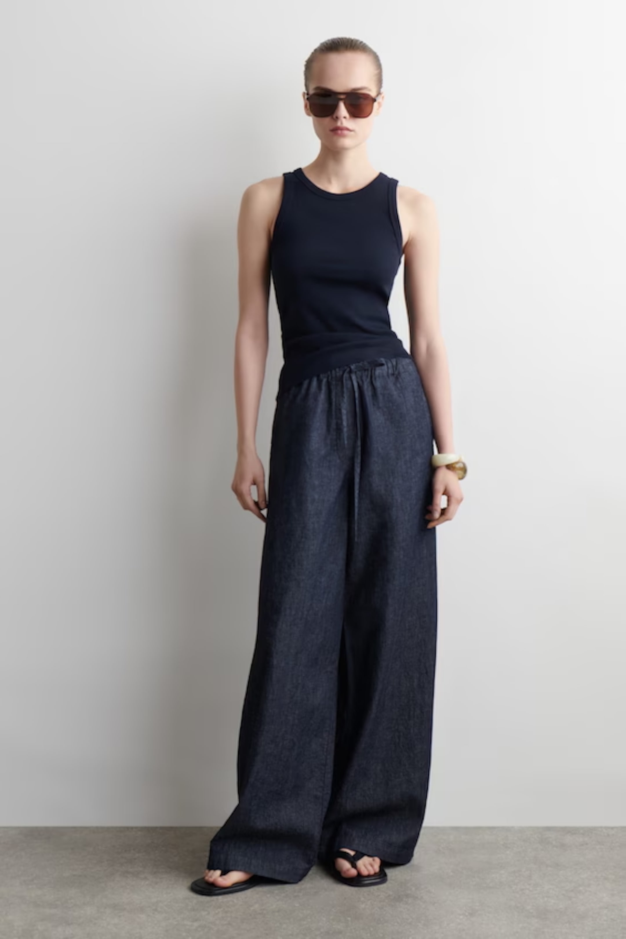 person wearing denim wide leg trousers