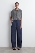 Placeholder for: person wearing denim wide leg trousers
