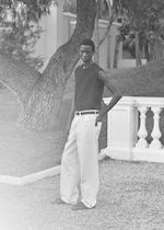 Placeholder for: man in white jeans and black vest