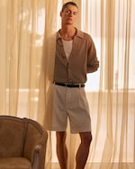 Placeholder for: man in shirt tucked into shorts with a black belt