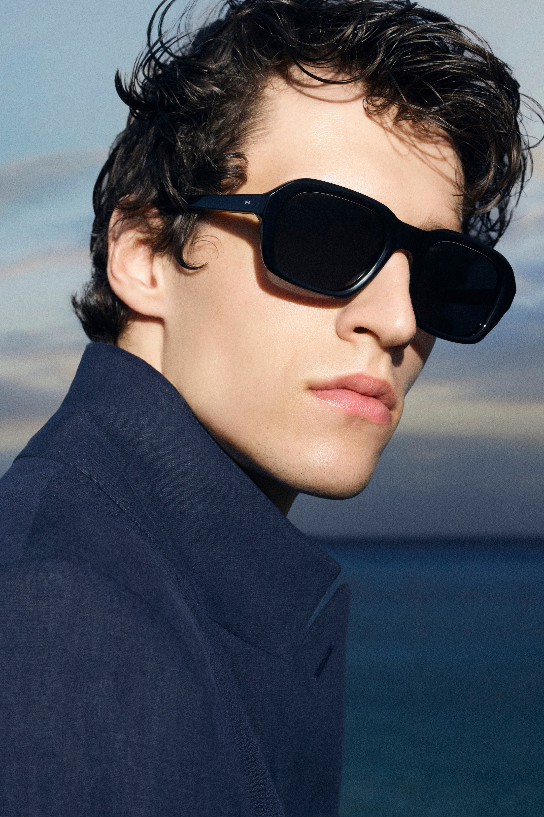 person wearing navy and sunglasses