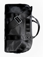 Placeholder for: Black duffel bag with a long adjustable strap and handle, showcasing a sleek and compact design against a white background.
