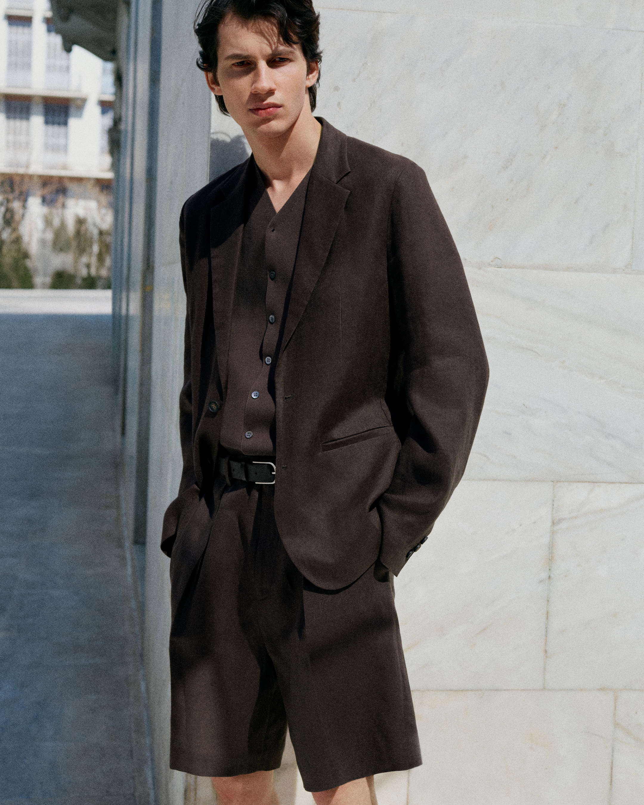 Model wearing brown linen suit and shorts