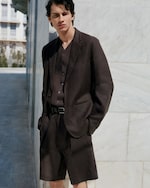 Placeholder for: Model wearing brown linen suit and shorts