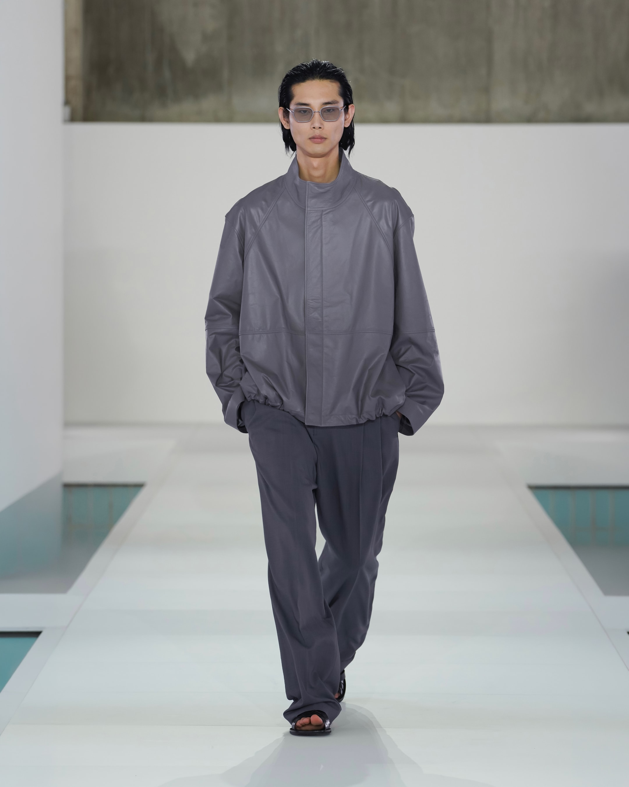 grey leather jacket and grey trousers