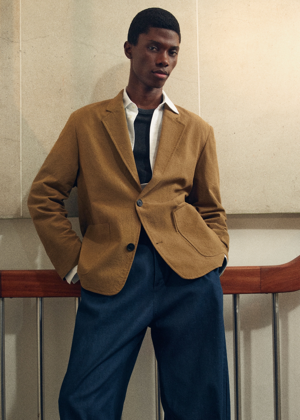 Man in blazer and navy trousers