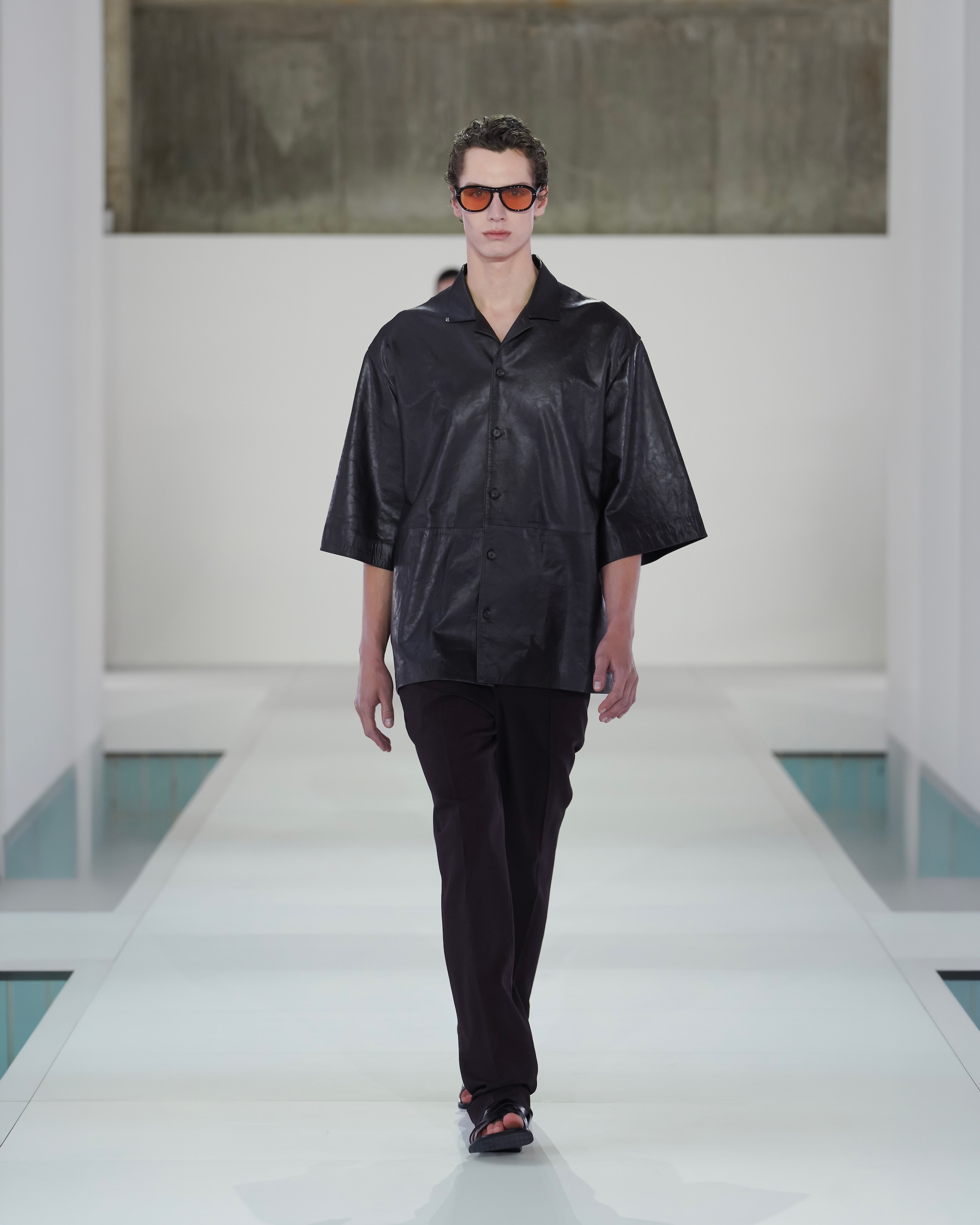 black leather shirt and dark brown trousers