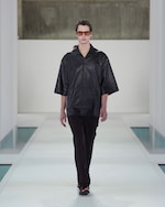 Placeholder for: black leather shirt and dark brown trousers