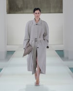Placeholder for: woman in beige oversized coat and bag and heels