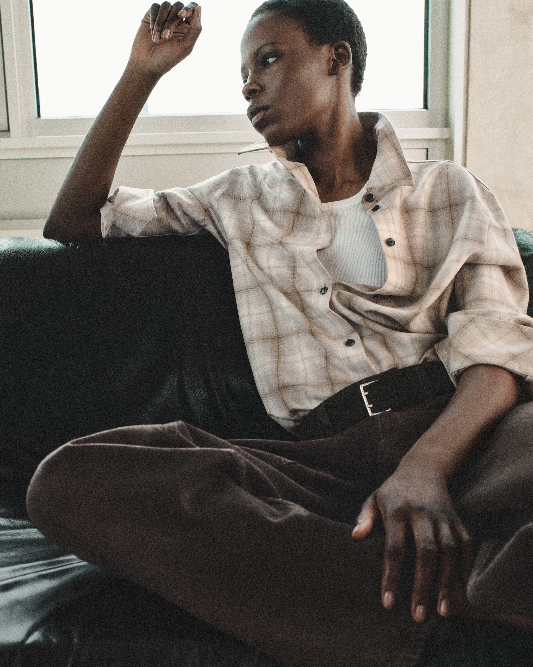 person wearing shirt and brown trousers