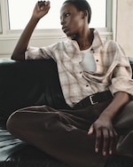 Placeholder for: person wearing shirt and brown trousers