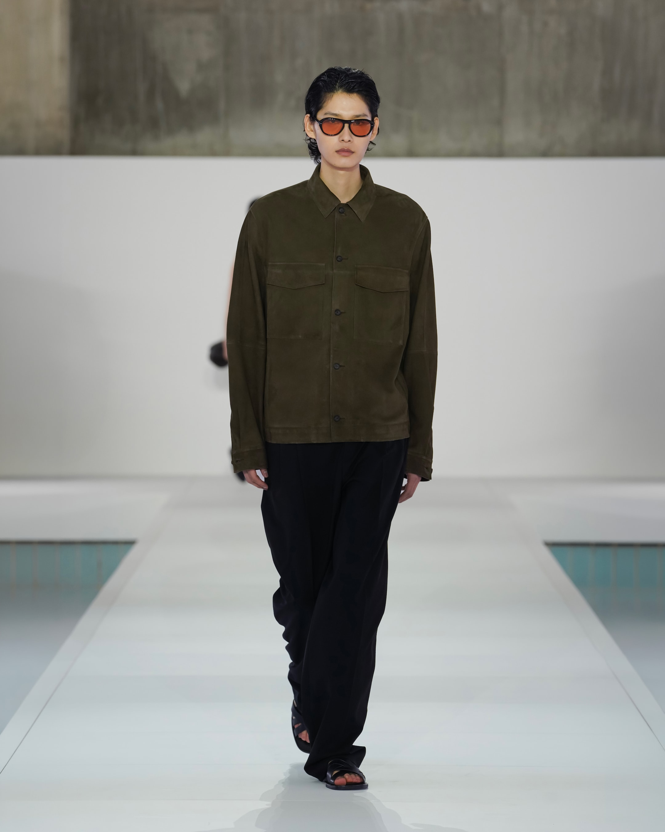 brown suede jacket and black trousers