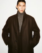 Placeholder for: Man in jacket with wool roll up