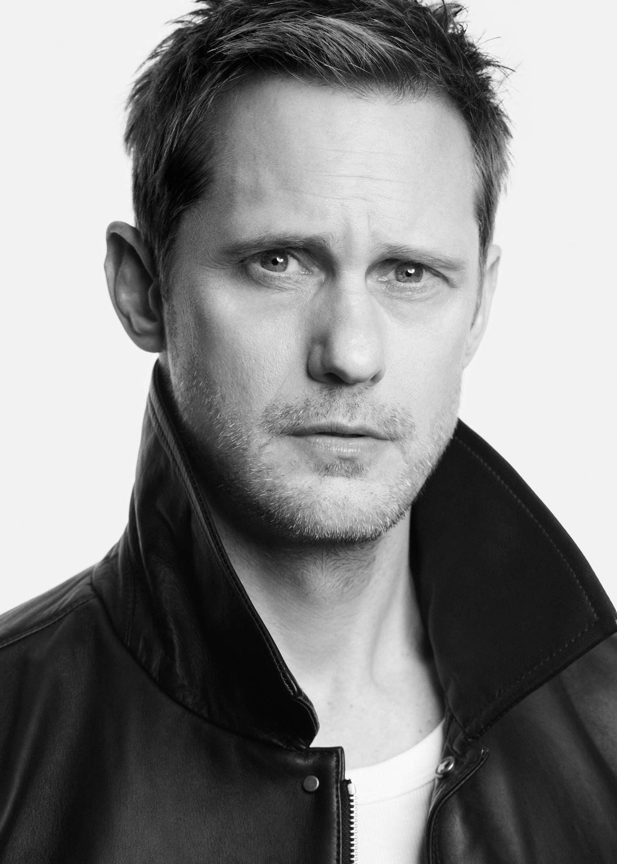 black and white photo of alex looking into the camera