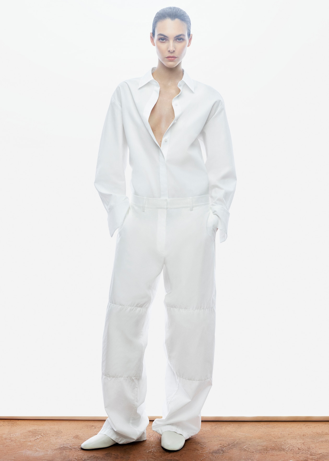 WOMAN IN ALL WHITE TROUSERS AND SHIRT