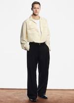 Placeholder for: Alex wearing butter yellow silk shirt and black trousers