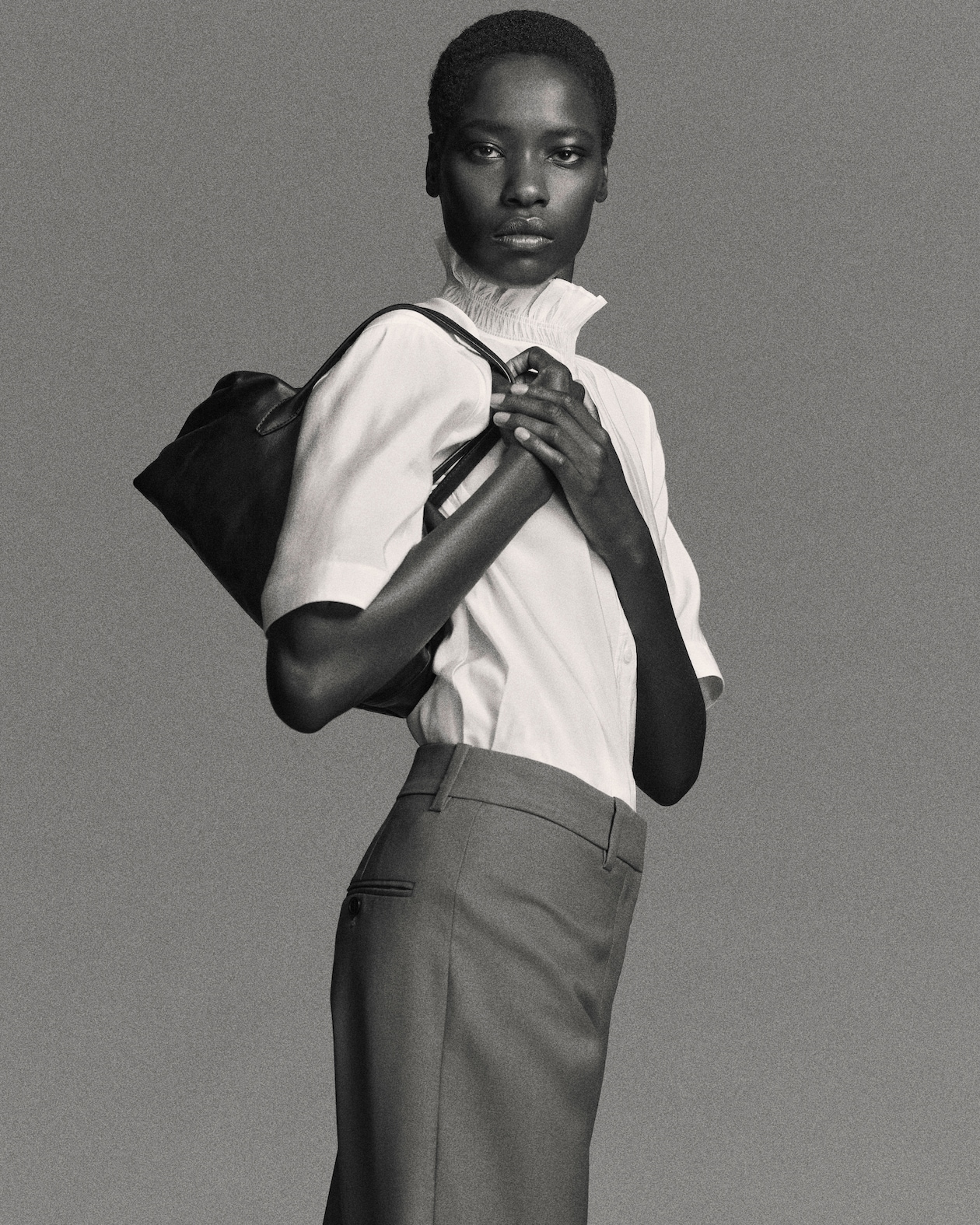 Woman in blouse holding bag