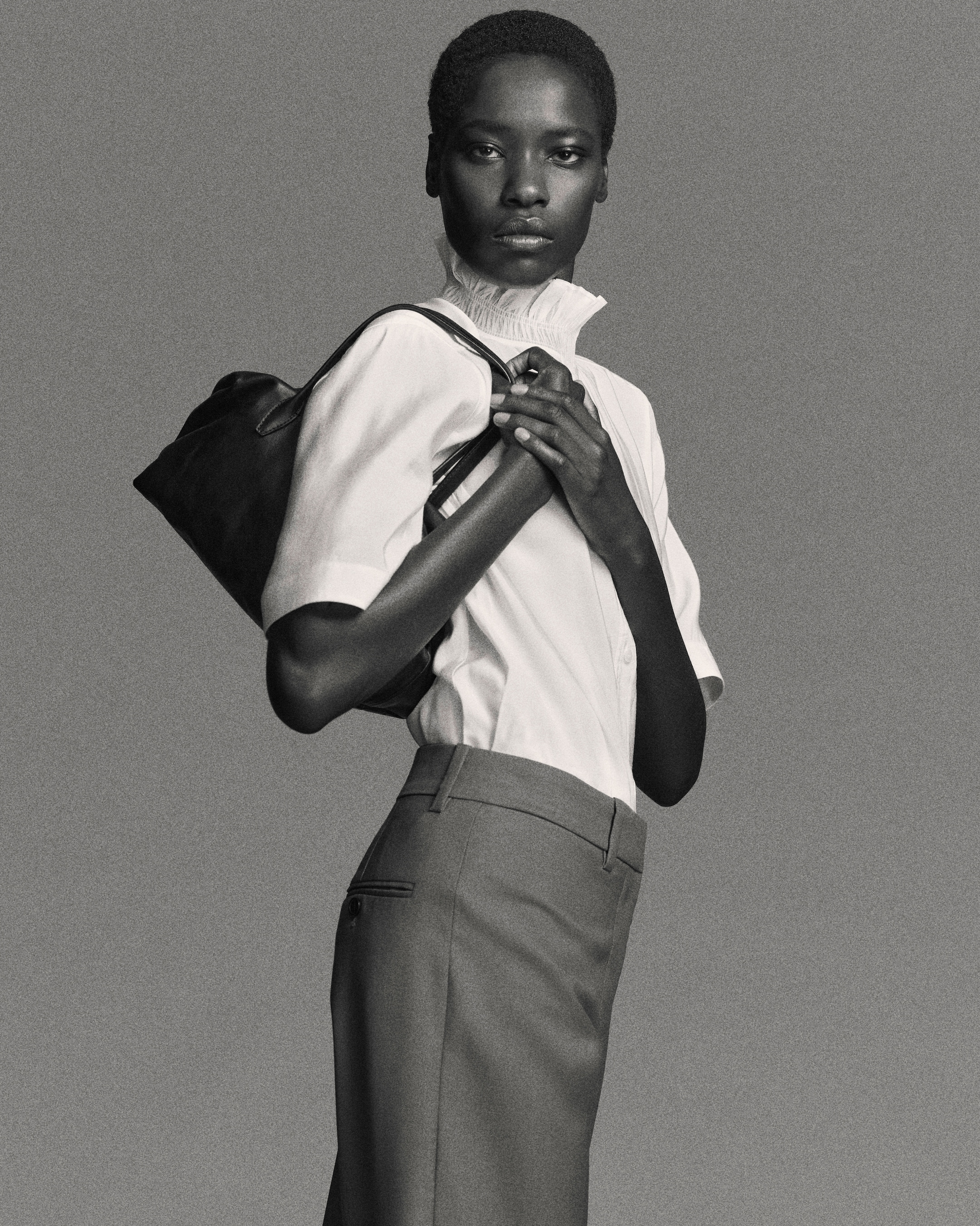 Woman in blouse holding bag