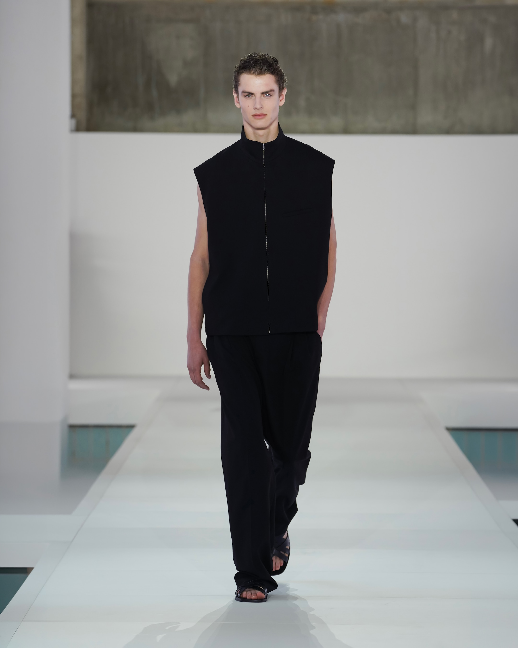 black gilet and black trousers