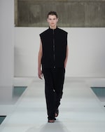 Placeholder for: black gilet and black trousers
