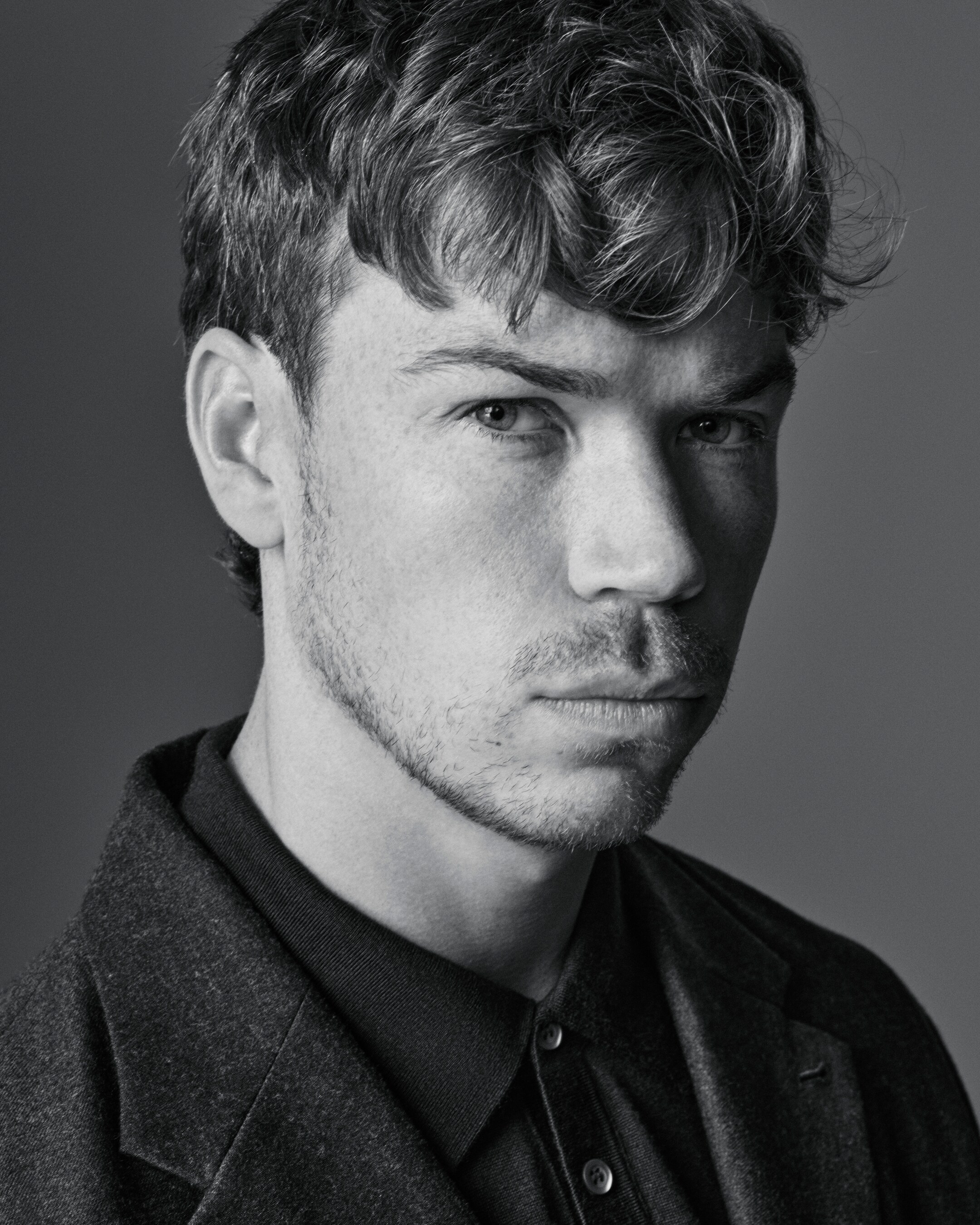 Man wears black shirt under wool coat