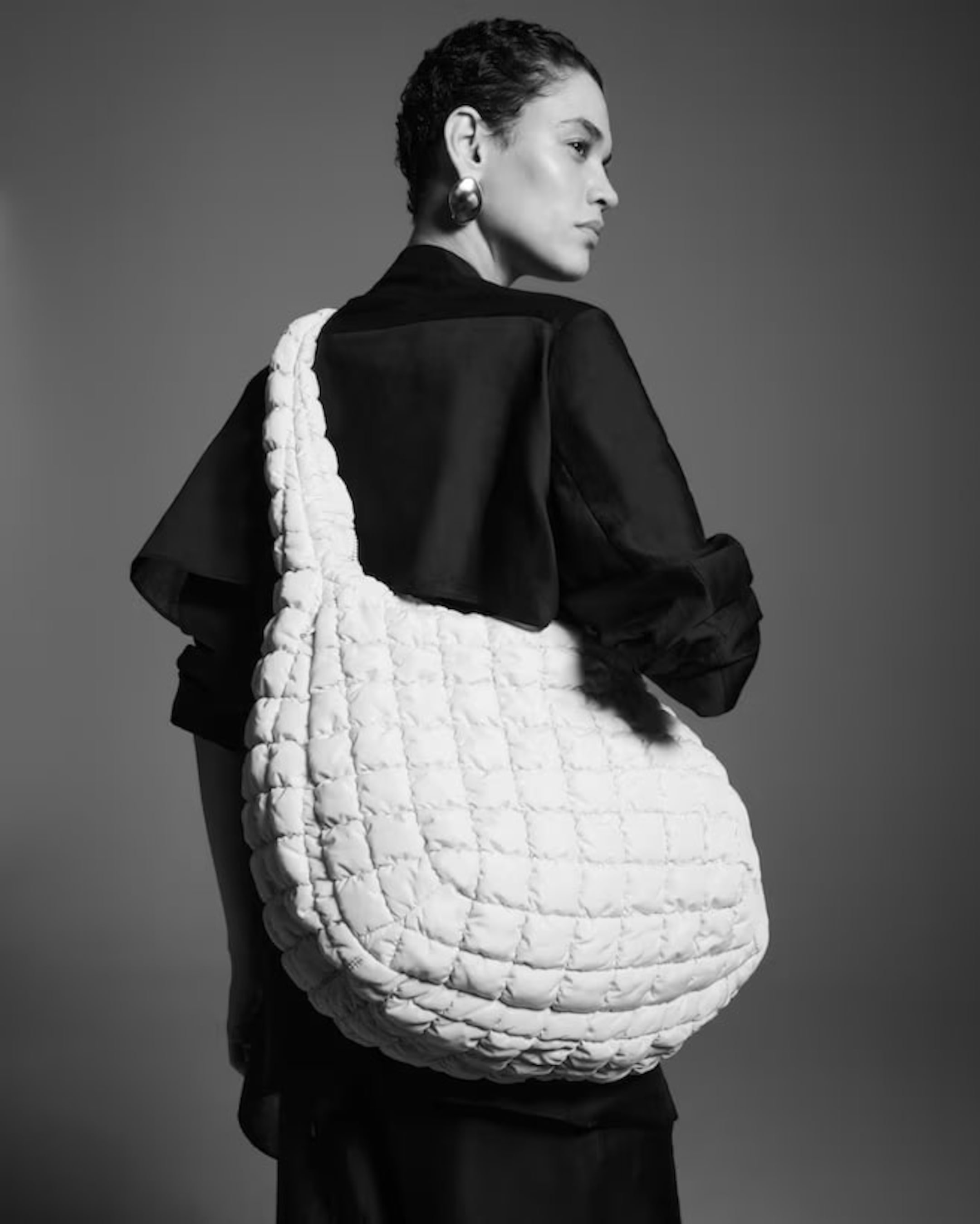woman in large quilted bag