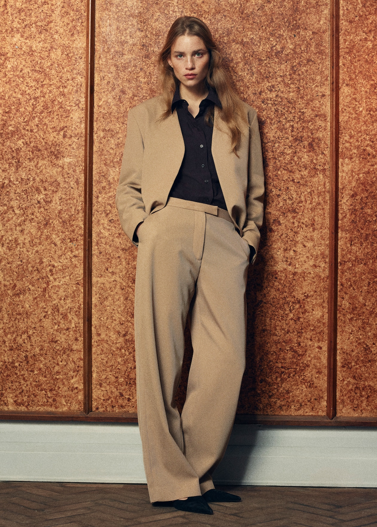 WOMAN IN TAN SUIT WITH BLACK SHIRT