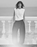 Placeholder for: person wearing summer wear with white vest and black trousers