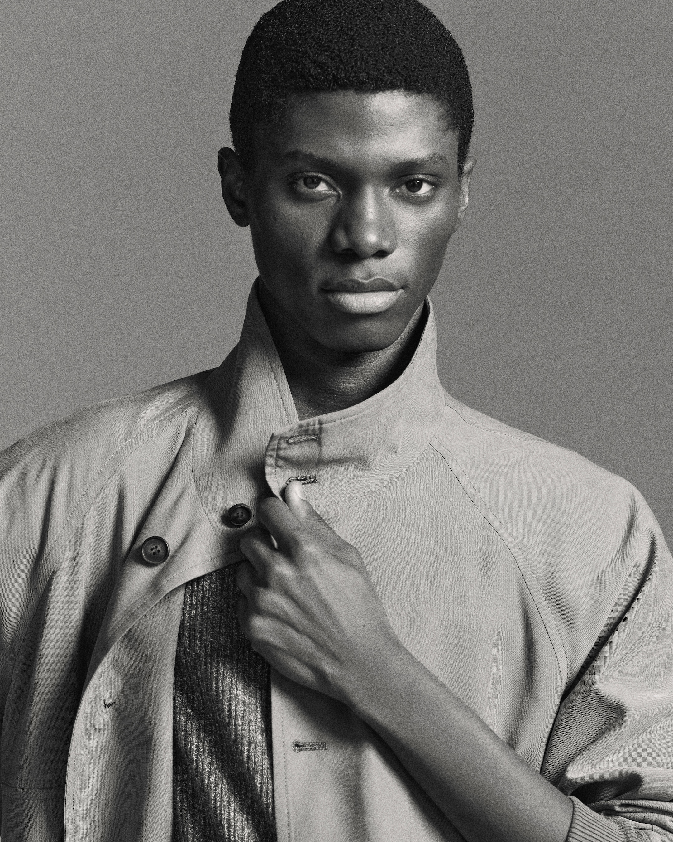 black and white picture of a man wearing khaki blouson